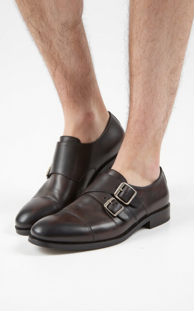 A male model wearing Buckle   up shoes, against a white background, with a close   up of the feet